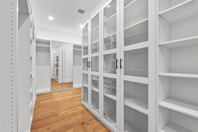 spacious closet featuring hardwood / wood-style floors