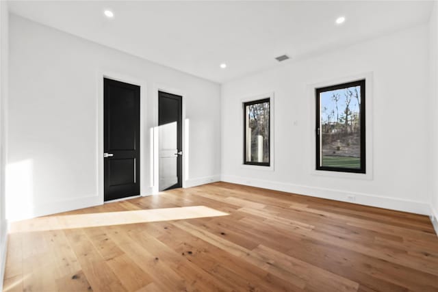 unfurnished room with light hardwood / wood-style floors