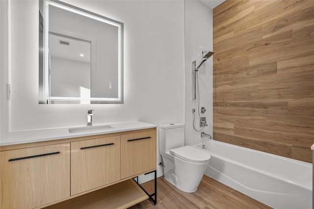 full bathroom featuring shower / bathing tub combination, toilet, vanity, and hardwood / wood-style flooring