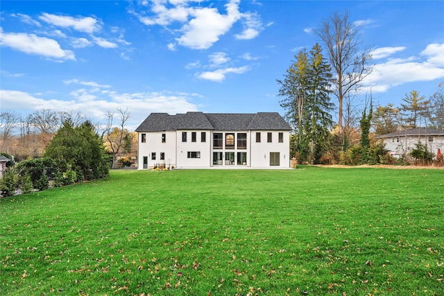 rear view of house with a yard