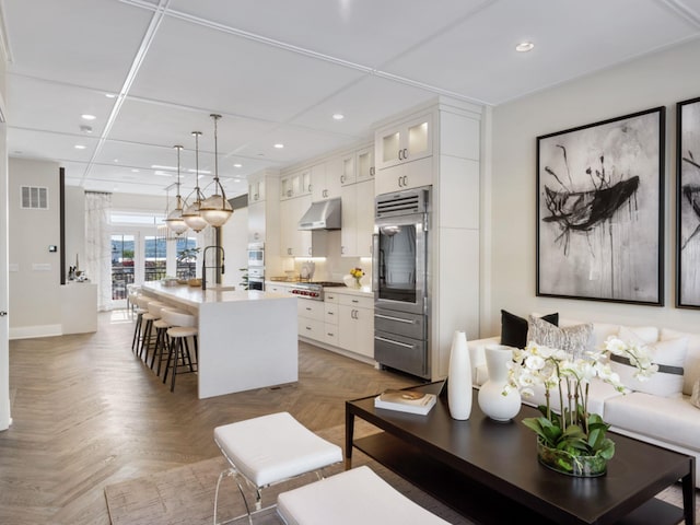 living room with dark parquet floors and sink