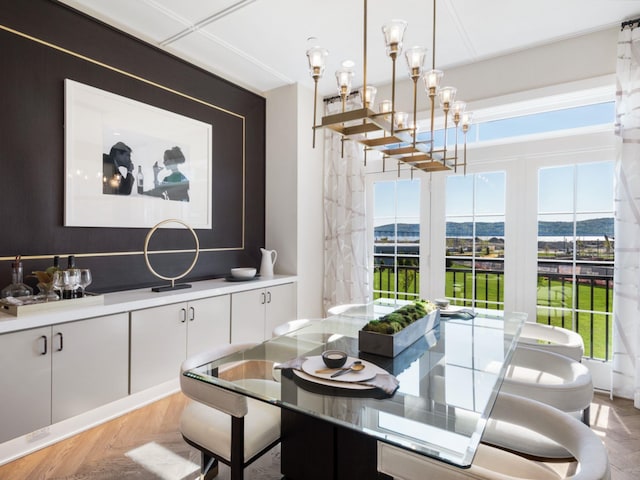 dining area featuring a notable chandelier and light parquet floors