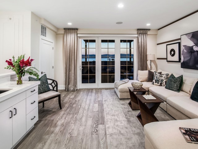 living room featuring french doors and hardwood / wood-style flooring