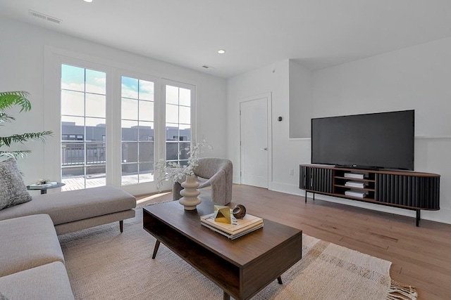 living area featuring recessed lighting, visible vents, and light wood-style floors