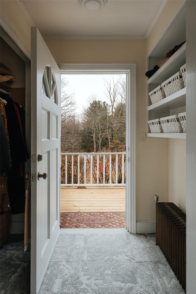 doorway to outside featuring hardwood / wood-style floors and ornamental molding