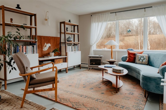 sitting room featuring concrete flooring and a baseboard heating unit