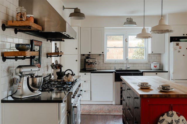 kitchen with wood counters, white appliances, white cabinets, decorative backsplash, and decorative light fixtures