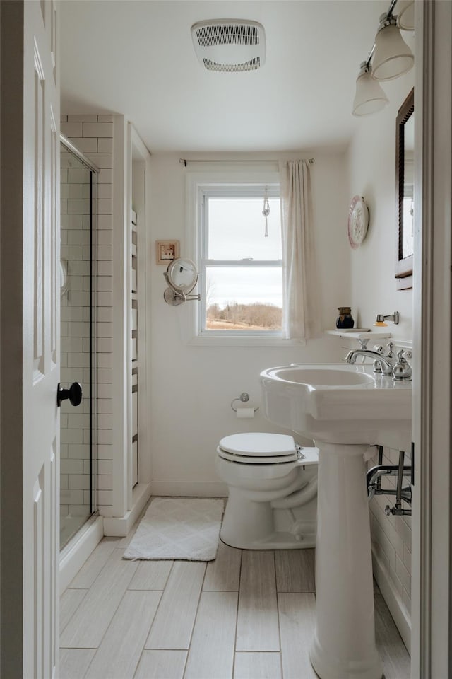 bathroom with toilet and walk in shower