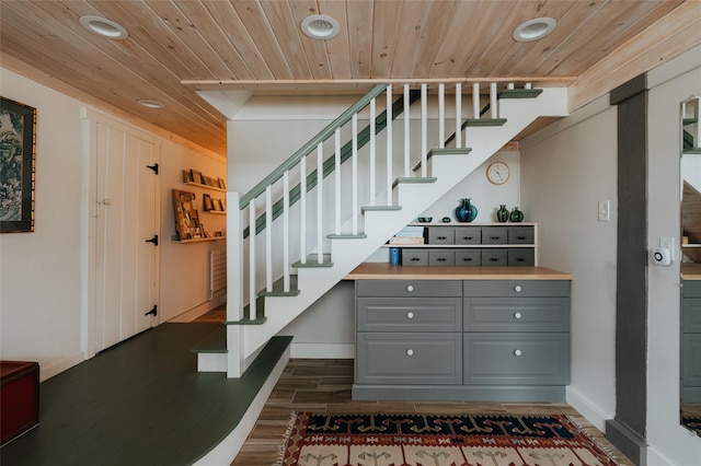 staircase featuring hardwood / wood-style flooring and wood ceiling