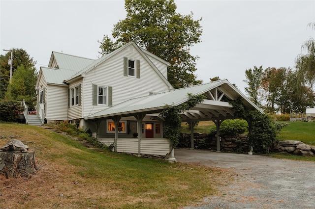 view of front facade with a front yard and a carport