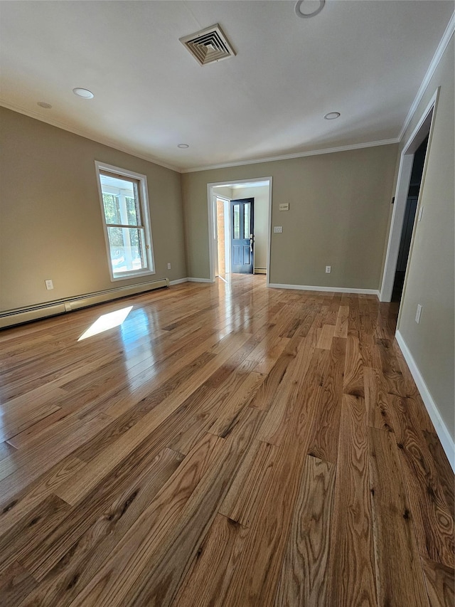 spare room with hardwood / wood-style floors and ornamental molding