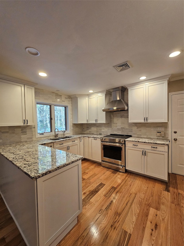 kitchen featuring wood walls, white cabinets, and light wood-type flooring