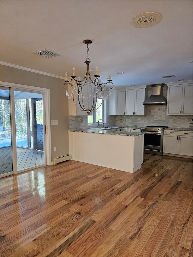 kitchen with wood walls, white cabinetry, and a wealth of natural light