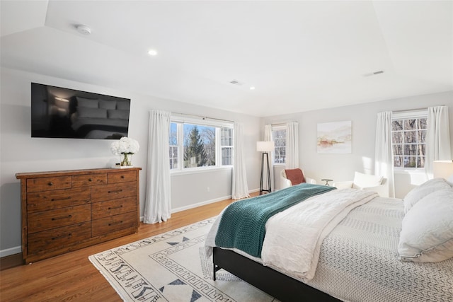 bedroom featuring recessed lighting, wood finished floors, visible vents, and baseboards