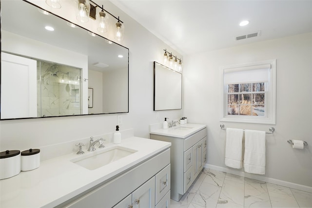 bathroom with a sink, visible vents, baseboards, marble finish floor, and a tile shower