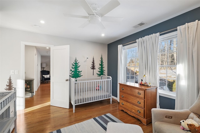 bedroom featuring recessed lighting, wood finished floors, a ceiling fan, baseboards, and visible vents