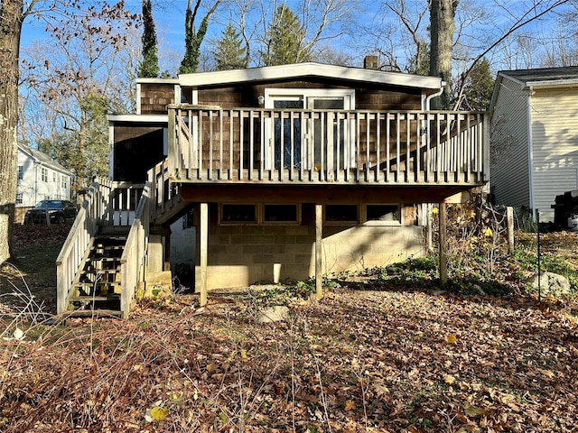 back of house with a deck