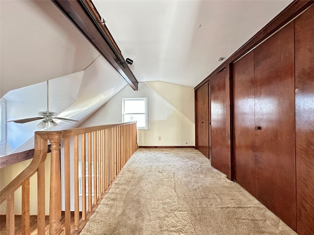 bonus room featuring vaulted ceiling with beams, ceiling fan, and light carpet