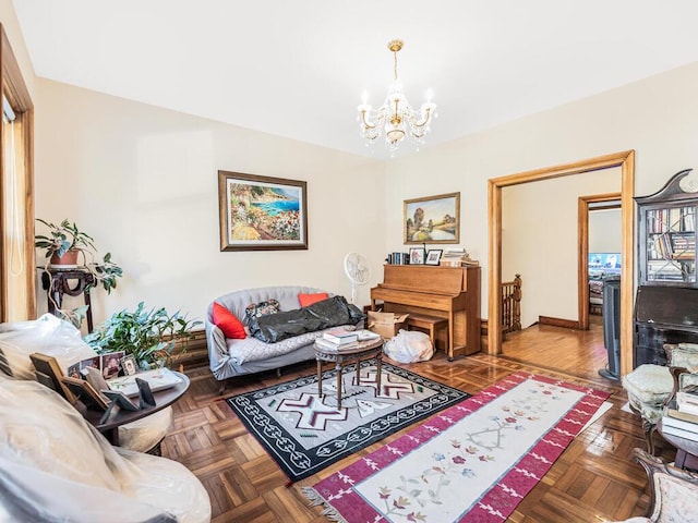 living room featuring parquet flooring and an inviting chandelier