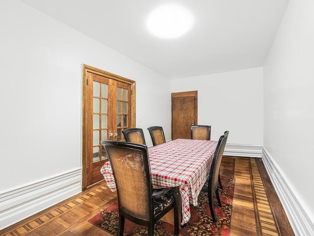 dining room with hardwood / wood-style floors and french doors