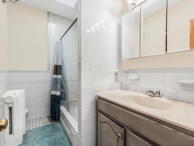 full bathroom with tile patterned flooring, radiator heating unit, shower / tub combo with curtain, and tile walls