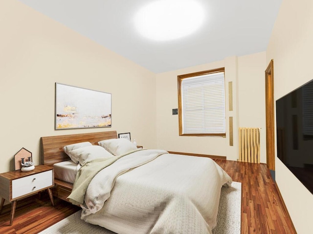 bedroom featuring radiator and dark hardwood / wood-style flooring