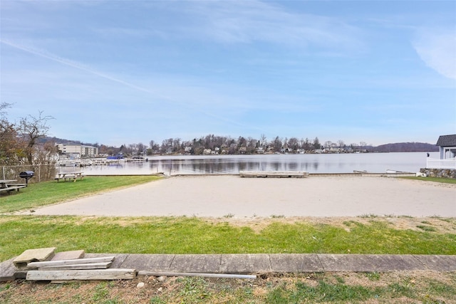 view of property's community featuring a yard and a water view