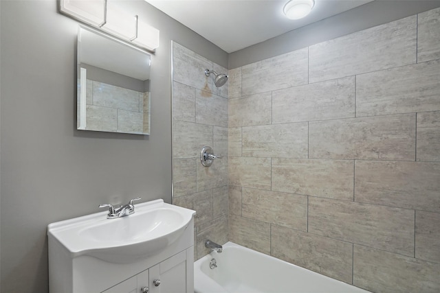 bathroom featuring vanity and tiled shower / bath