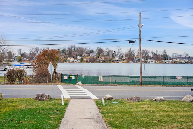 view of street with a water view and sidewalks