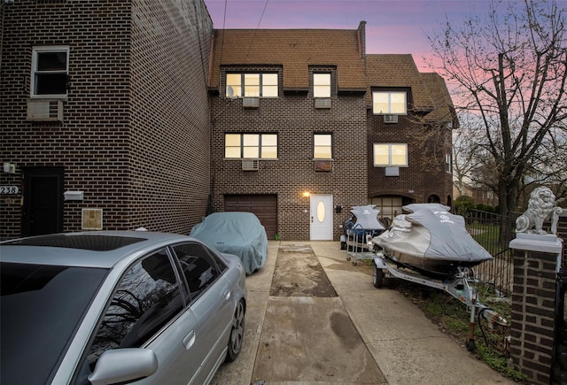 property exterior at dusk featuring a garage