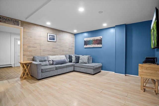 living room with light hardwood / wood-style flooring and a baseboard heating unit