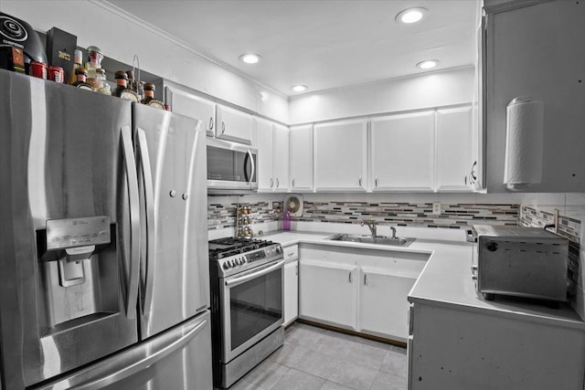 kitchen featuring white cabinets, appliances with stainless steel finishes, and sink