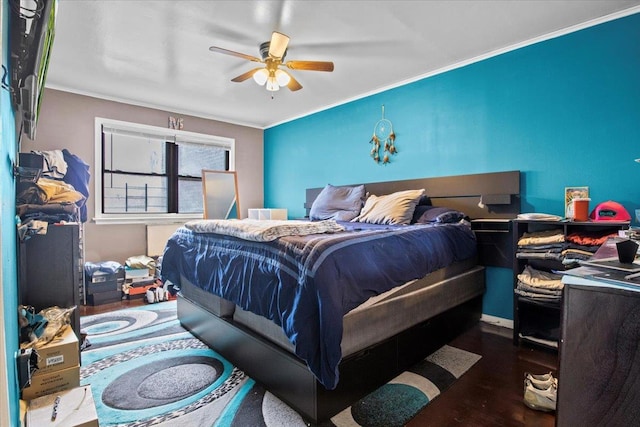 bedroom with ceiling fan, ornamental molding, and dark wood-type flooring