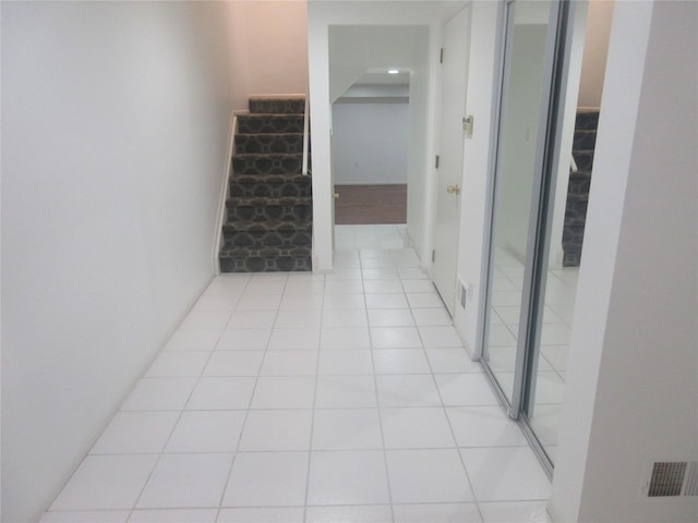 corridor with light tile patterned floors