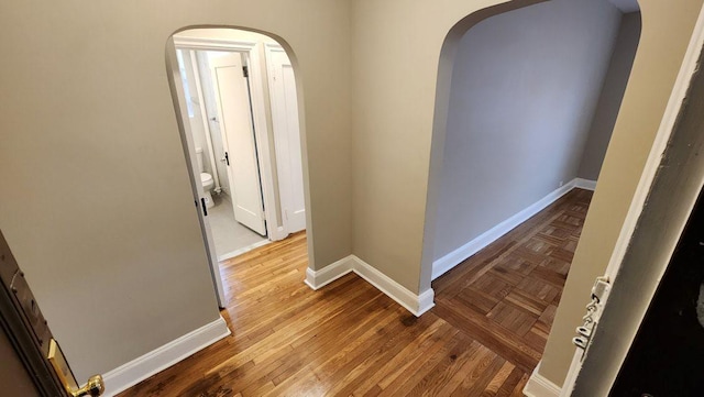 corridor with hardwood / wood-style floors