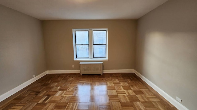 unfurnished room featuring parquet flooring