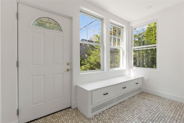 tiled foyer featuring plenty of natural light