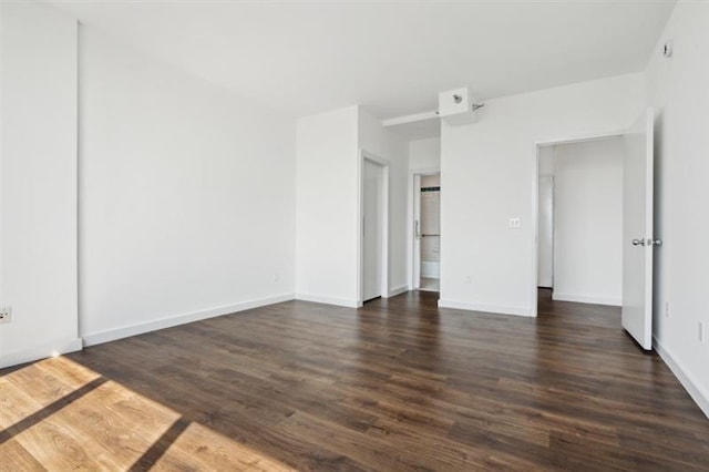 unfurnished bedroom with dark hardwood / wood-style flooring