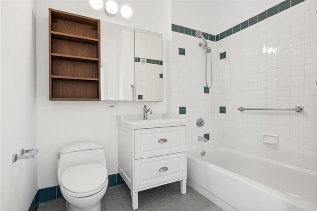 full bathroom with tile patterned floors, vanity, tiled shower / bath combo, and toilet