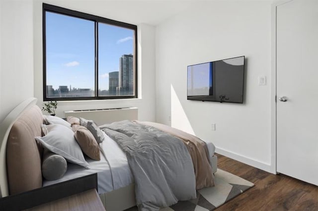 bedroom with dark hardwood / wood-style floors