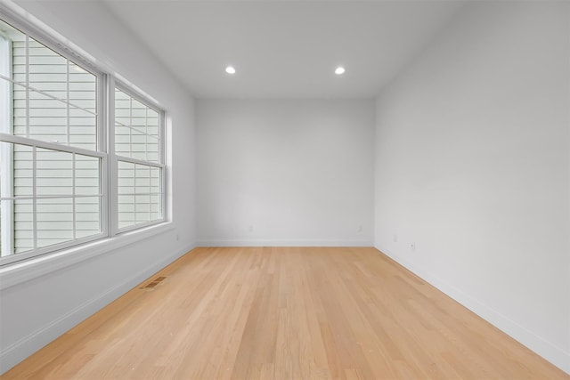 unfurnished room with light hardwood / wood-style floors