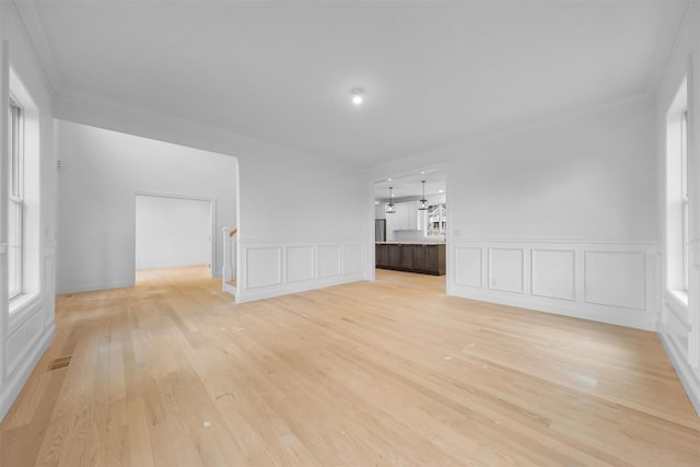 interior space featuring plenty of natural light and ornamental molding