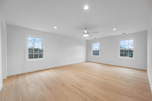 unfurnished room with ceiling fan and light hardwood / wood-style floors