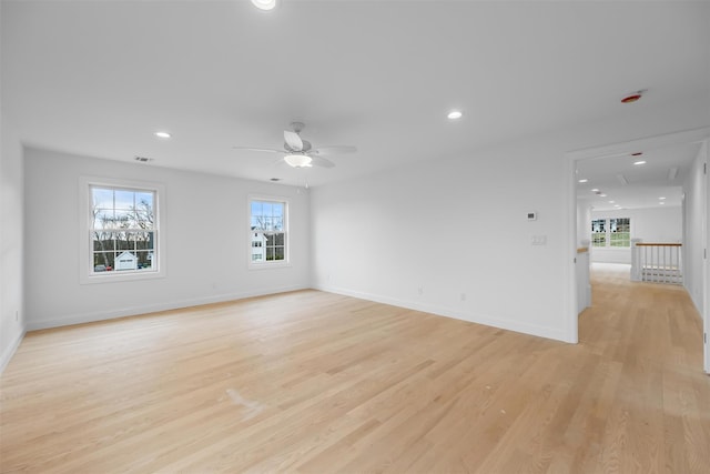 unfurnished room with ceiling fan and light hardwood / wood-style flooring