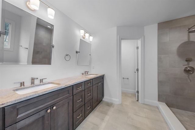 bathroom featuring vanity and tiled shower