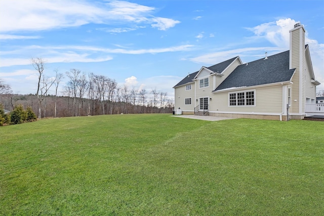 back of property featuring a patio area and a yard