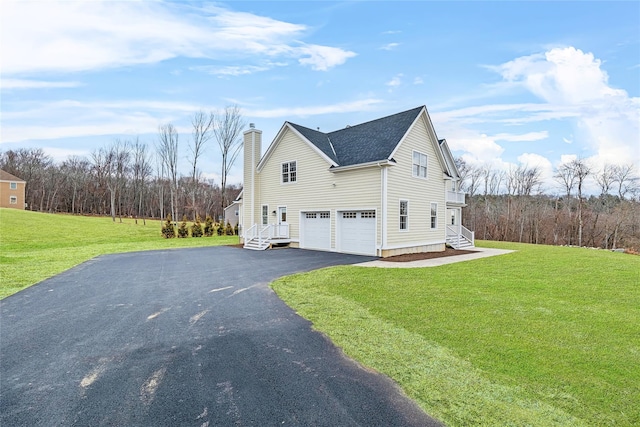 view of side of property with a garage and a yard