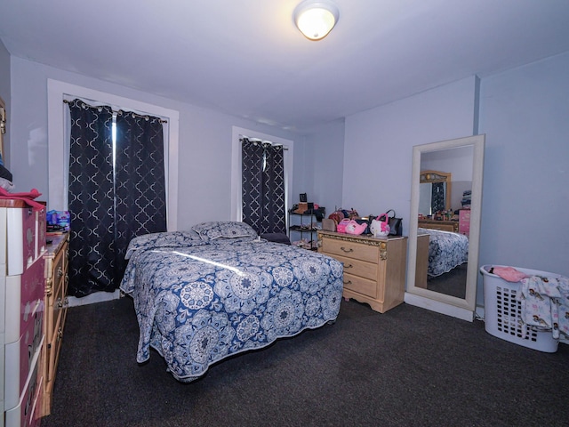 bedroom featuring dark colored carpet