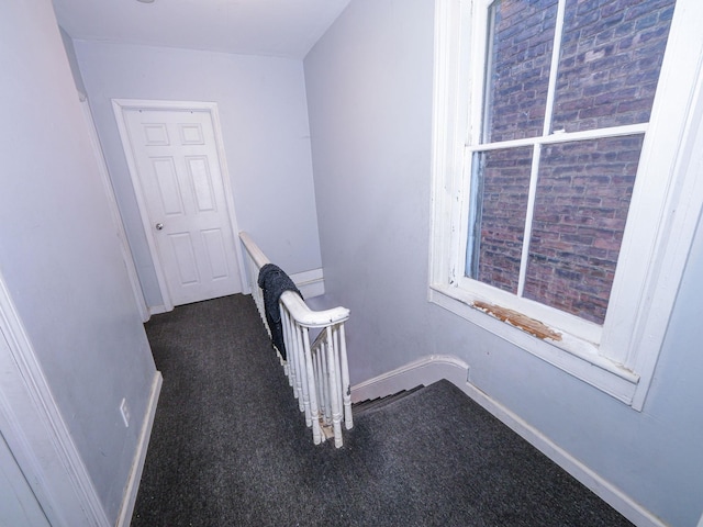 hallway with dark carpet