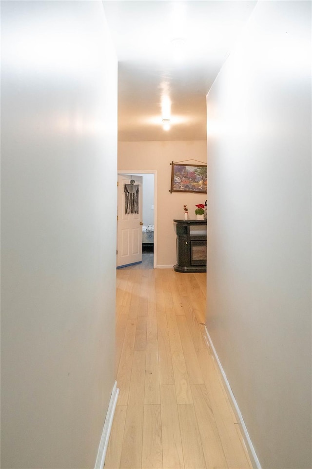 corridor with light wood-type flooring